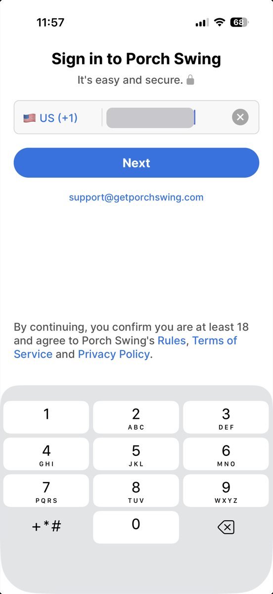 The Porch Swing sign-in screen. A country selector reading US (+1) and a phone number field the member types into, with a Next button beneath it. Grey bars cover the number for privacy.